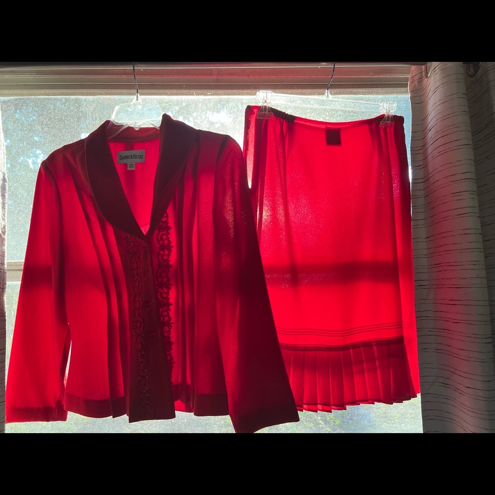 Bright red women’s suit. Skirt and jacket